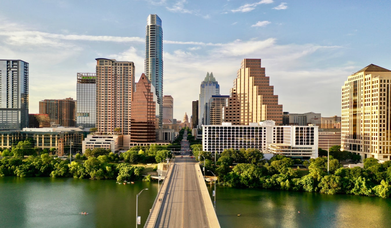 The towering skyline of Austin, Texas as seen from over a bridge