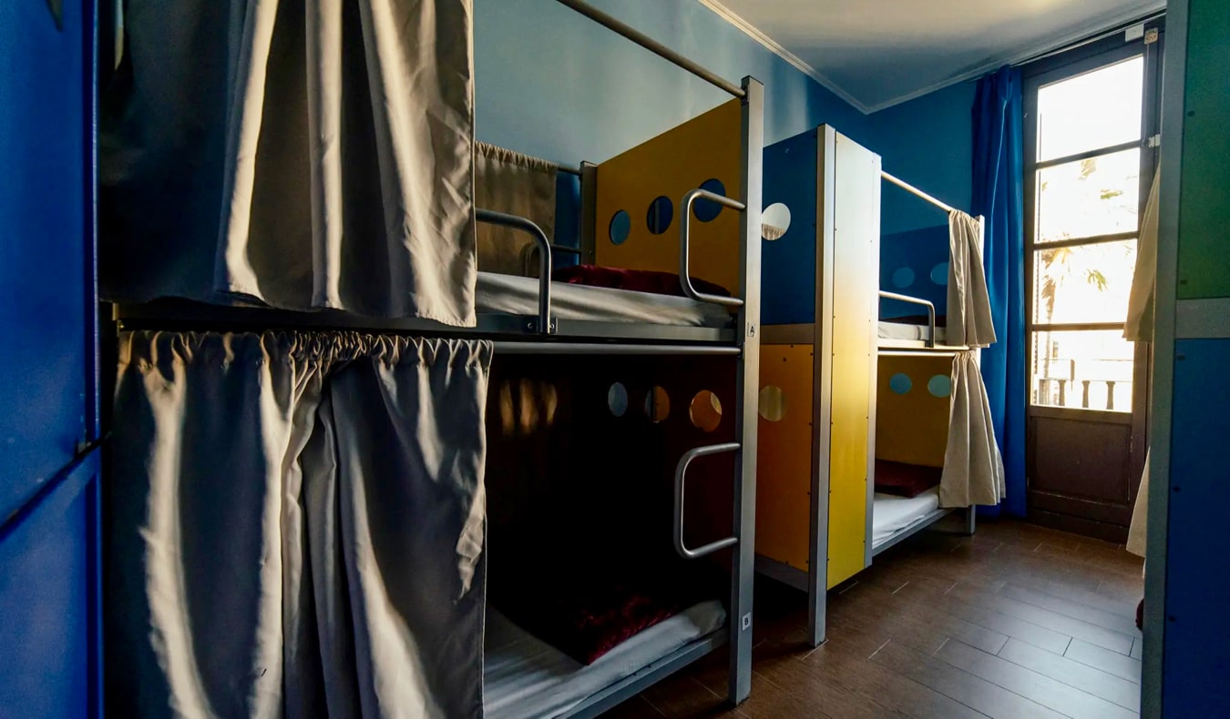 The dark interior of a dorm room at the Kabul Party Hostel in Barcelona, Spain