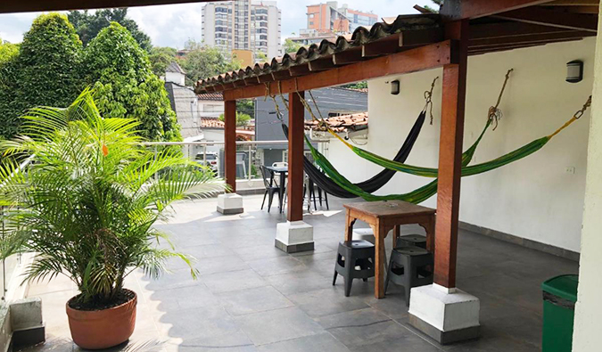 Hammocks hanging on outdoor roof terrace at Black Sheep Hostel, Medellin