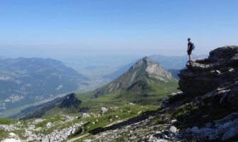 A solo traveler looking out over mountains