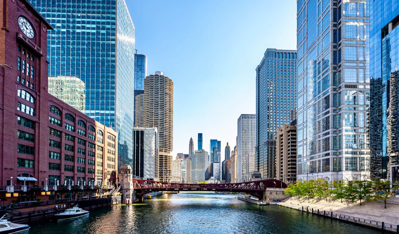 A busy downtown Chicago, USA divided by the river on a quiet, sunny day with a bridge in the distance