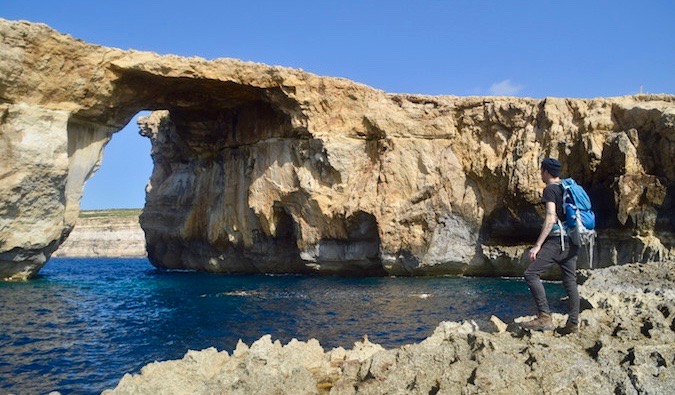 vegan traveler Chris Oldfield at the Azure Window in Malta