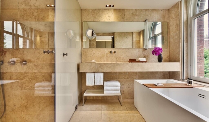 Luxurious bathroom with a deep soaking tub at Conservatorium Hotel in Amsterdam, the Netherlands