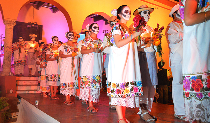 People wearing traditional makeup for day of the dead