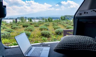 A laptop in a van as a digital nomad admires Mount Fuji in Japan