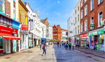 A sunny day in the Old Town of Dublin, Ireland as people walk around and shop