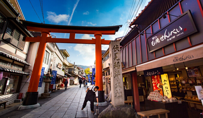 Japanese street scene food shops and a people walking down the street