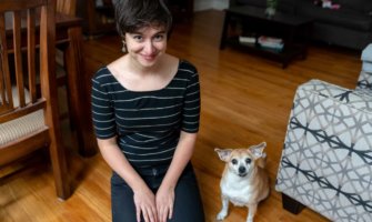 Sam, the lead researcher for Nomadic Matt, posing with a dog while house sitting