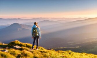 A solo female traveler hiking in the mountains