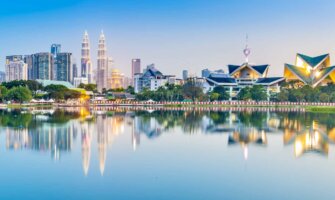 The view overlooking stunning Kuala Lumpur, Malaysia as seen from a nearby park with a lake