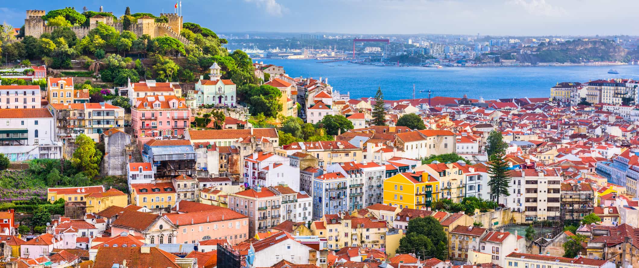 pretty red rooftops in Lisbon,Portugal with cadtle Sao George in the background