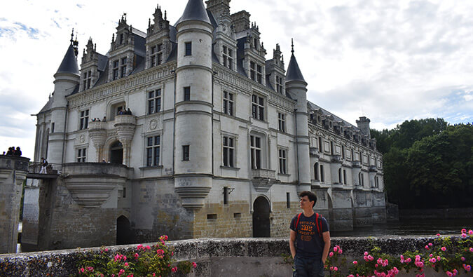 Nomadic Matt stood in front of an historic building