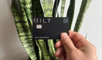 Matt's Bilt Rewards Mastercard being held up in front of a snake plant