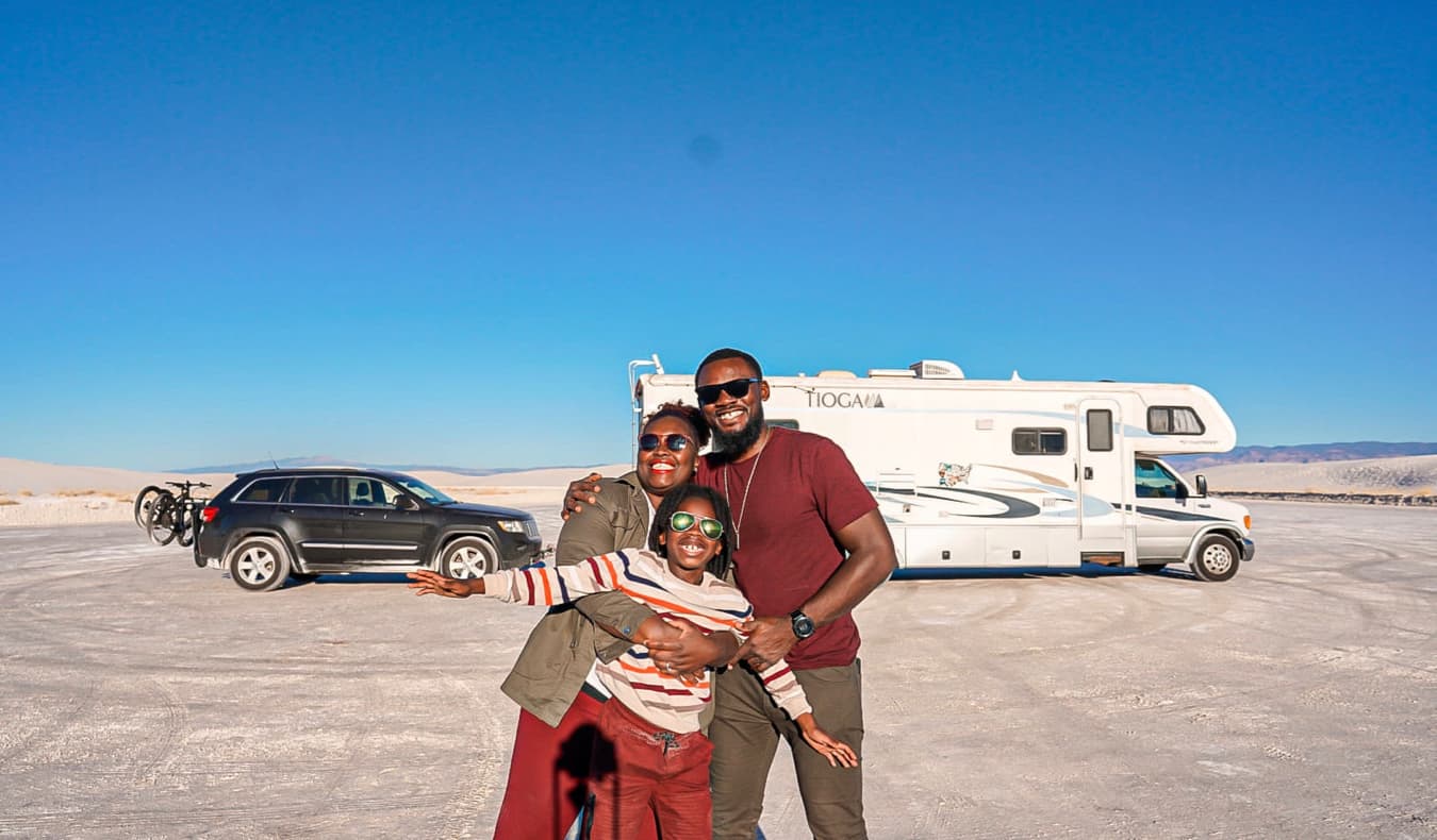 Karen from The Mom Trotter and her family posing near their RV