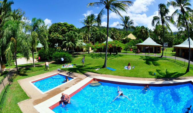 Birdseye view of yard with two swimming pools at Nomads Noosa hostel in Noosa, Australia