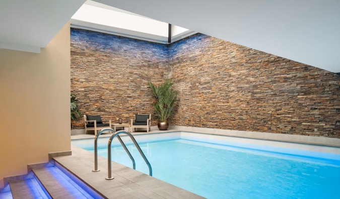 Indoor swimming pool with a large skylight over it at Park Plaza Victoria hotel in Amsterdam, the Netherlands