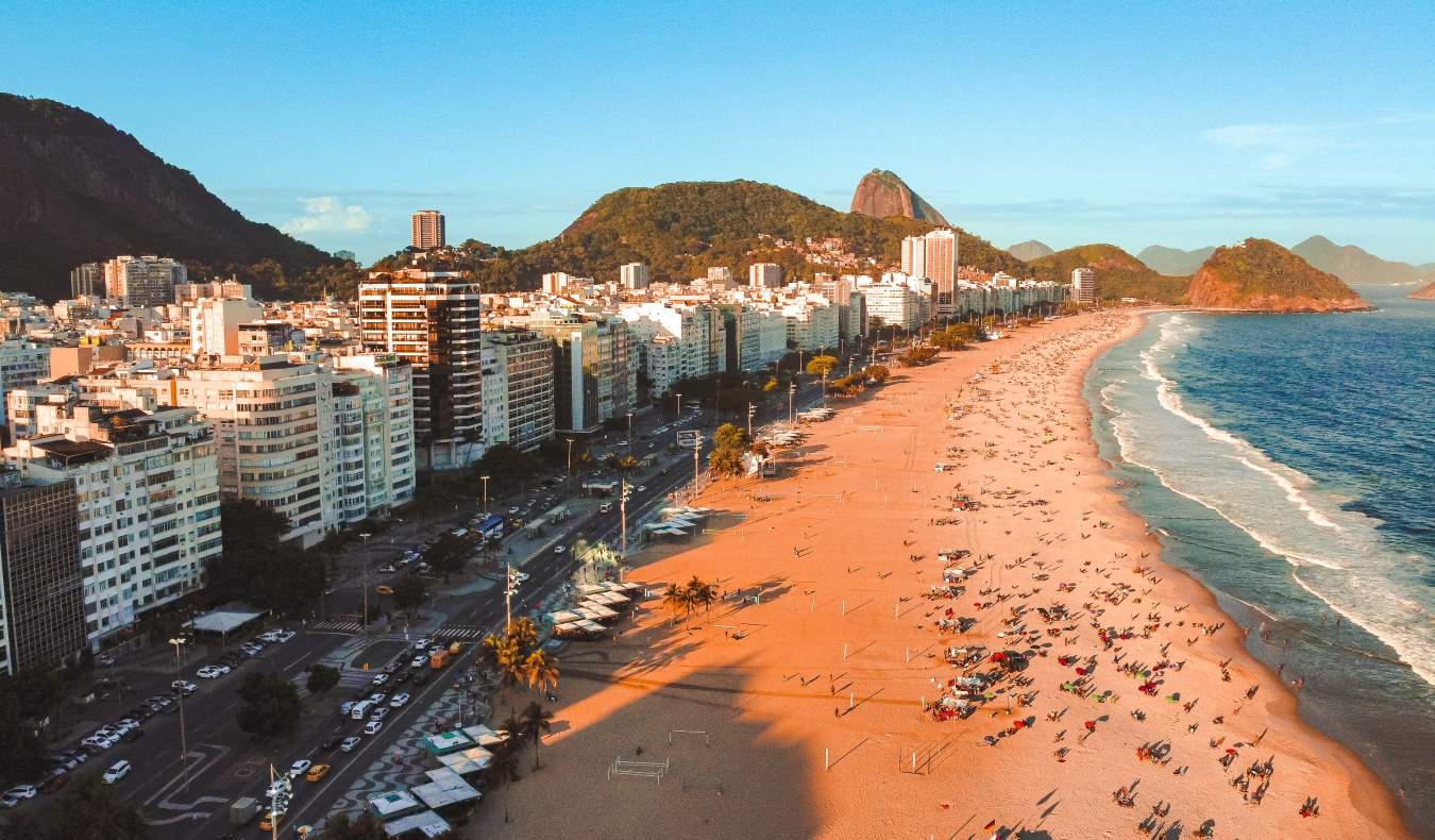 Long stretch of beach lined with multistory buildings in Rio de Janeiro, Brazil