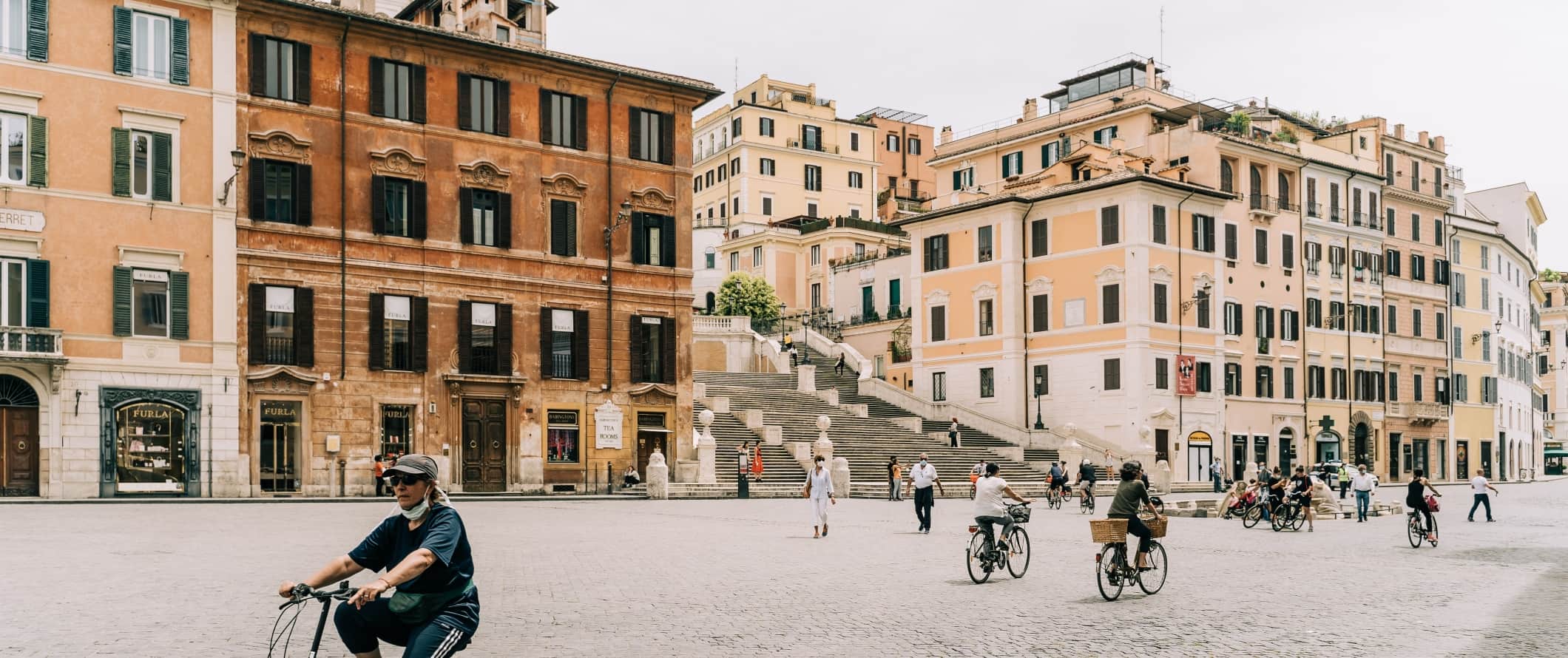 People cycling on the street in Rome, Italy