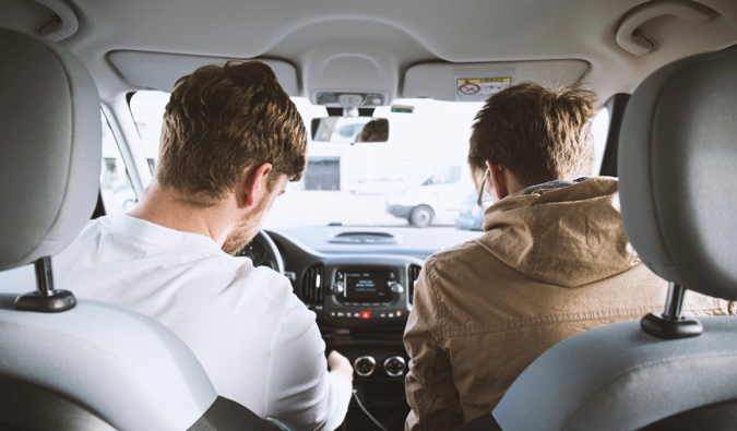 Two friends in a car together starting a road trip