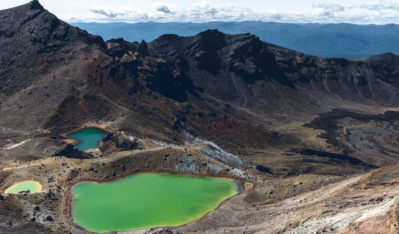 The emerald green lakes against the stark volcanic landscape of Tongariro Alpine Crossing, a hike in New Zealand