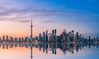 A beautiful pastel sky over the downtwon skyline of Toronto, Ontario on the shore of Lake Ontario