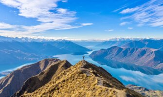 A solo hiker climbing the hills on scenic New Zealand on a beautiful day