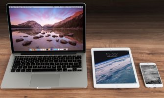 A laptop, tablet, and smartphone sitting on a desk