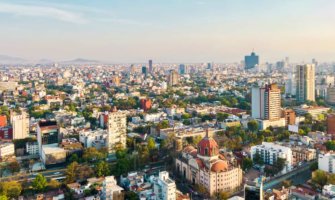 The skyline of Mexico City, Mexico and its towering skyscrapers and lush greenery