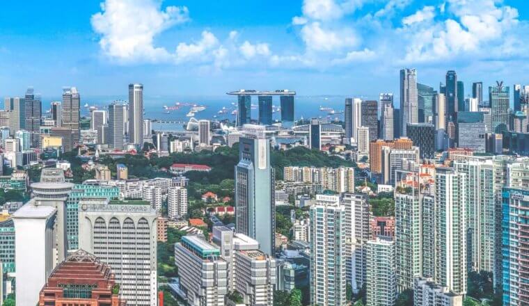 The Singapore city skyline, densely packed with skyscrapers on a sunny day