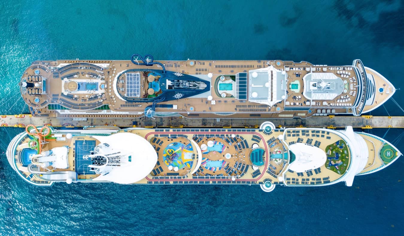 Two massive cruise ships docked side by side in the harbor